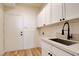 Convenient laundry room with a deep sink, modern faucet, and ample storage at 8080 Black Orchid Ave, Las Vegas, NV 89131