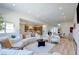 Open-concept living room seamlessly connects to kitchen and dining areas for easy entertaining at 8080 Black Orchid Ave, Las Vegas, NV 89131