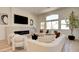 Stylish living room with modern fireplace, neutral tones, large windows, and comfortable seating arrangement at 8080 Black Orchid Ave, Las Vegas, NV 89131