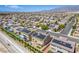 A stunning aerial view captures a community of homes with desert landscaping, solar panels, and scenic mountain backdrop at 813 Bluebird Hill Ave, North Las Vegas, NV 89084