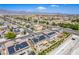 Expansive aerial view of a neighborhood featuring modern homes with solar panels and mountain views at 813 Bluebird Hill Ave, North Las Vegas, NV 89084