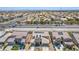 An aerial shot reveals a well-planned community, featuring homes equipped with solar panels amidst desert landscaping at 813 Bluebird Hill Ave, North Las Vegas, NV 89084