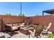 This beautiful outdoor patio features a seating area with a brick privacy wall and desert landscaping at 813 Bluebird Hill Ave, North Las Vegas, NV 89084