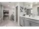 Bathroom with double vanity sinks, grey cabinetry and a large mirror, offering a modern and spacious feel at 813 Bluebird Hill Ave, North Las Vegas, NV 89084
