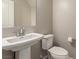 Neutral powder bathroom with a pedestal sink and modern fixtures at 813 Bluebird Hill Ave, North Las Vegas, NV 89084