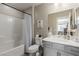 Bright bathroom featuring a tub with a shower, a white toilet, and a gray vanity with a white countertop at 813 Bluebird Hill Ave, North Las Vegas, NV 89084