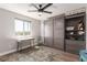 Bedroom with a built-in Murphy bed, a desk, a rug, wood floors, and a window at 813 Bluebird Hill Ave, North Las Vegas, NV 89084