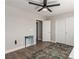 Bedroom featuring a decorative rug on wood-look flooring, neutral walls, closet doors, and access to an adjoining room at 813 Bluebird Hill Ave, North Las Vegas, NV 89084