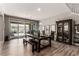 Dining area with a large wood table, bench seating, and sliding glass doors to the backyard at 813 Bluebird Hill Ave, North Las Vegas, NV 89084