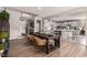 Open-concept dining area with a large table and chairs, flowing into the kitchen and entryway at 813 Bluebird Hill Ave, North Las Vegas, NV 89084