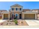 Beautiful two-story home boasts a well-manicured front yard and a symmetrical facade, complete with a two-car garage at 813 Bluebird Hill Ave, North Las Vegas, NV 89084