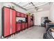 The garage has red and black metal cabinets with shelving that provides extra storage at 813 Bluebird Hill Ave, North Las Vegas, NV 89084