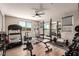 Bright home gym featuring multiple exercise machines, free weights, and mirrored wall at 813 Bluebird Hill Ave, North Las Vegas, NV 89084