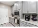Stylish kitchen with built-in microwave, stainless steel oven, light gray cabinets, and white countertops at 813 Bluebird Hill Ave, North Las Vegas, NV 89084