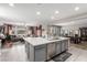 Open concept kitchen with island, stainless steel dishwasher, sink, and breakfast bar seating at 813 Bluebird Hill Ave, North Las Vegas, NV 89084