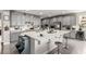 Kitchen with gray cabinetry, stainless appliances, a center island with bar stools, and tile flooring at 813 Bluebird Hill Ave, North Las Vegas, NV 89084