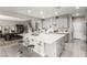 Bright, spacious kitchen with a large island, breakfast bar, stainless steel appliances, and gray cabinetry at 813 Bluebird Hill Ave, North Las Vegas, NV 89084