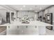 Spacious kitchen featuring a large island with breakfast bar seating, stainless steel appliances, and ample cabinet space at 813 Bluebird Hill Ave, North Las Vegas, NV 89084