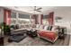 Comfortable living room with a large sectional sofa, modern ceiling fan, and neutral decor, perfect for relaxation at 813 Bluebird Hill Ave, North Las Vegas, NV 89084