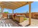 Outdoor kitchen under a pergola with built-in grill, stainless steel drawers, and counter space at 813 Bluebird Hill Ave, North Las Vegas, NV 89084