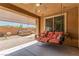 Relaxing covered patio features a swing, hot tub, and view of the landscaped backyard, inviting outdoor enjoyment at 813 Bluebird Hill Ave, North Las Vegas, NV 89084
