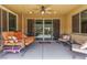 Covered patio with ceiling fan, swing, seating area, and sliding glass doors to the interior at 813 Bluebird Hill Ave, North Las Vegas, NV 89084