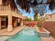 Inviting backyard with a private pool, patio area, and lush landscaping at 8267 Campbell Springs Ave, Las Vegas, NV 89178