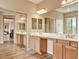 Bright bathroom featuring double sinks, and sliding mirrored doors at 8267 Campbell Springs Ave, Las Vegas, NV 89178