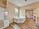 Bathroom featuring a corner bathtub and a glass-enclosed shower at 8267 Campbell Springs Ave, Las Vegas, NV 89178