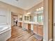 Bright bathroom featuring double sinks, bathtub and sliding mirrored doors at 8267 Campbell Springs Ave, Las Vegas, NV 89178