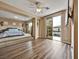 Bedroom featuring a raised bed platform, bright window, and sliding door access to balcony at 8267 Campbell Springs Ave, Las Vegas, NV 89178