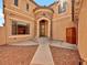 Stunning two-story home featuring a stone turret entry and desert landscaping at 8267 Campbell Springs Ave, Las Vegas, NV 89178
