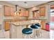 Kitchen island with breakfast bar, stainless appliances, and granite countertops at 8267 Campbell Springs Ave, Las Vegas, NV 89178