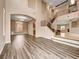 Spacious living room featuring hardwood floors, high ceilings, and staircase with iron railing at 8267 Campbell Springs Ave, Las Vegas, NV 89178