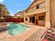 Backyard oasis featuring a private pool, covered patio, and manicured landscaping at 8267 Campbell Springs Ave, Las Vegas, NV 89178