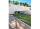 The backyard shows a grassy lawn, brick-lined flowerbeds, and a concrete block fence at 8328 Cimarron Ridge Dr, Las Vegas, NV 89128