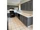 The kitchen boasts ample cabinetry, sleek appliances, and tile flooring at 8328 Cimarron Ridge Dr, Las Vegas, NV 89128