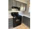 The kitchen showcases gas range, dark cabinets, sleek countertops, and tile floors at 8328 Cimarron Ridge Dr, Las Vegas, NV 89128