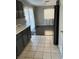 The kitchen has dark cabinets, light countertops, tile floors, and dark wood laminate flooring at 8328 Cimarron Ridge Dr, Las Vegas, NV 89128