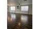 Bright living room featuring hardwood floors, large windows, and neutral walls at 8328 Cimarron Ridge Dr, Las Vegas, NV 89128