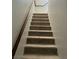 Carpeted staircase with a wooden handrail at 8328 Cimarron Ridge Dr, Las Vegas, NV 89128