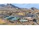 Aerial view of community pool, baseball field, and tennis courts with a mountain backdrop at 8904 Evening Star Dr, Las Vegas, NV 89134
