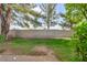 The backyard has gravel and grass with mature trees and a block wall at 8904 Evening Star Dr, Las Vegas, NV 89134