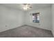 Bedroom with neutral carpet, a ceiling fan and a window with exterior views at 8904 Evening Star Dr, Las Vegas, NV 89134