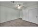 Bedroom featuring neutral carpet, ceiling fan and a closet with sliding doors at 8904 Evening Star Dr, Las Vegas, NV 89134