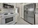 Well-equipped kitchen featuring stainless steel appliances, white cabinetry, and tile flooring for a sleek, modern look at 8904 Evening Star Dr, Las Vegas, NV 89134