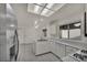 Well-lit kitchen featuring white cabinets, stainless steel appliances, and tile flooring at 8904 Evening Star Dr, Las Vegas, NV 89134