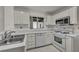 Modern kitchen featuring stainless steel sink, white cabinets, and modern appliances at 8904 Evening Star Dr, Las Vegas, NV 89134