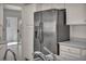 Close up of a stainless steel refrigerator with white cabinets, tile flooring and sink at 8904 Evening Star Dr, Las Vegas, NV 89134
