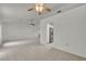 Spacious living room featuring neutral tile flooring, ceiling fans, and ample natural light at 8904 Evening Star Dr, Las Vegas, NV 89134